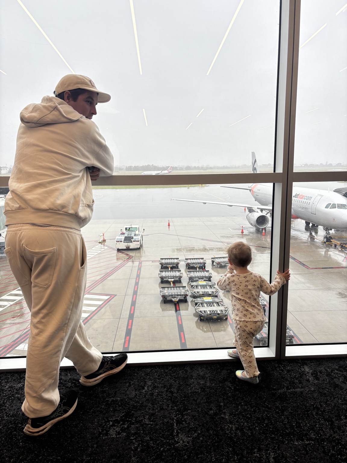 Greg and Paloma watching planes through the airport window