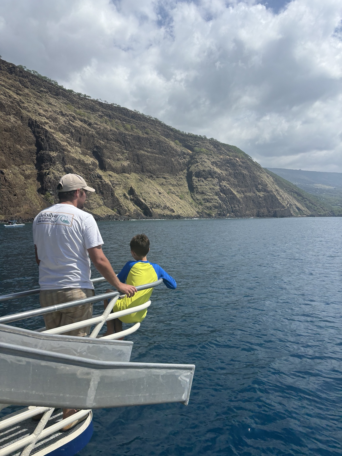 Greg and a child exploring the Hawaiian coast by boat
